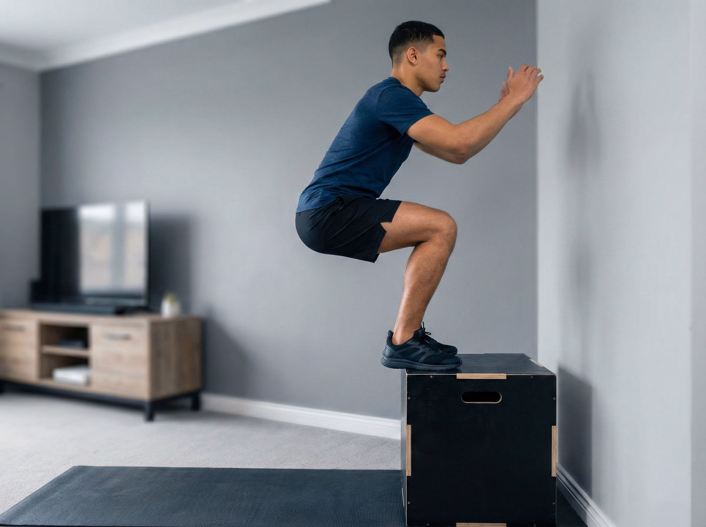 Teen landing softly on a box with blue glow through legs and spine