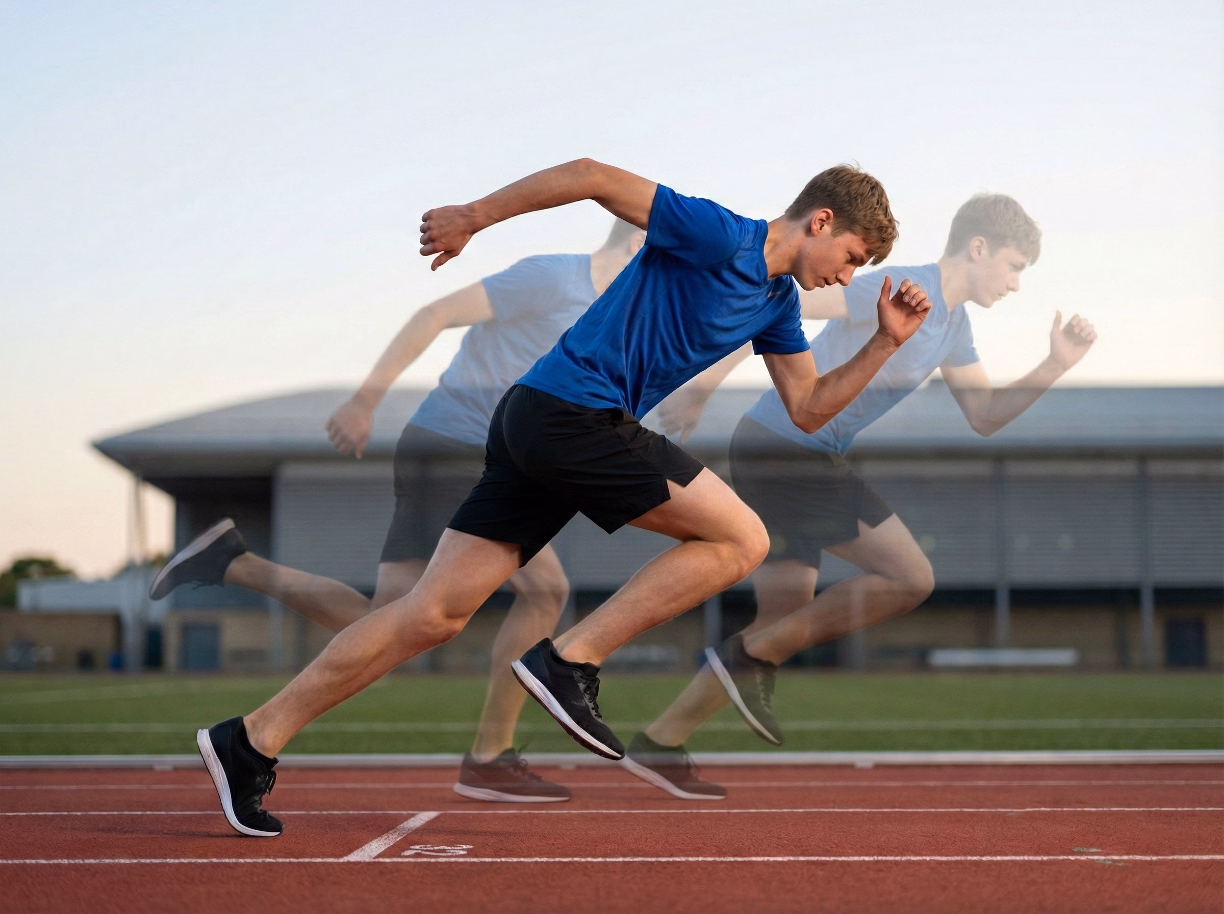 Side view of teen sprinting with blue line from foot through legs to head