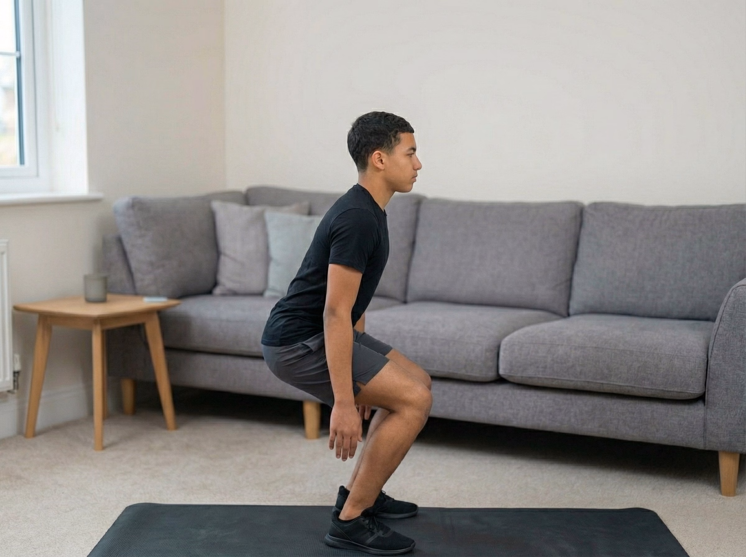 Teen in a deep squat with blue glow through legs and torso