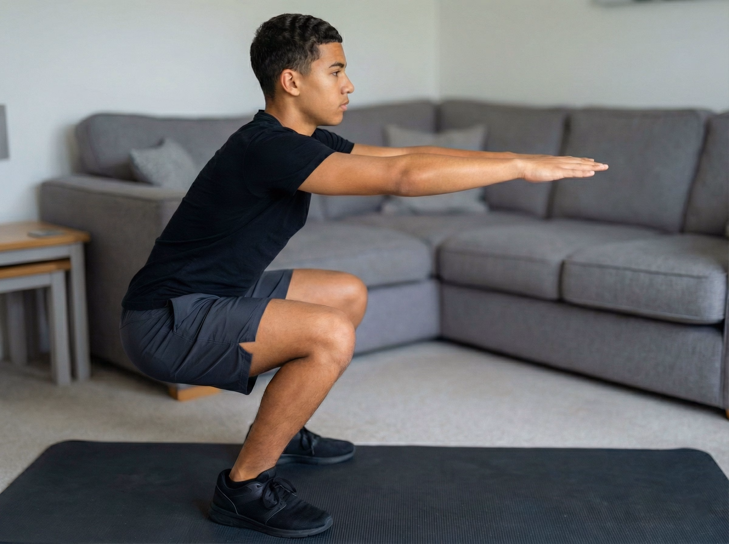 Step 3 – Teen in deep squat starting to drive up with a vertical blue glow