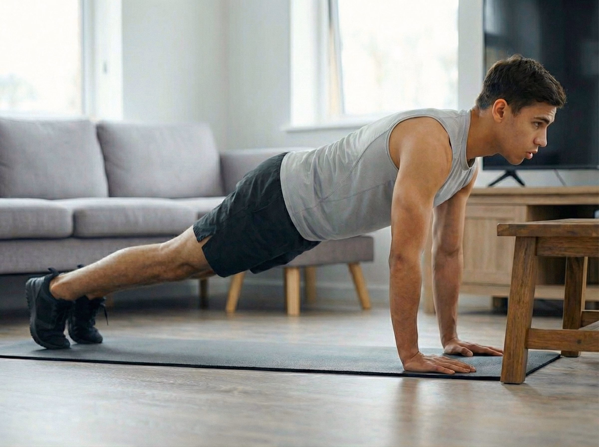 Elevated plank variation on a bench or counter