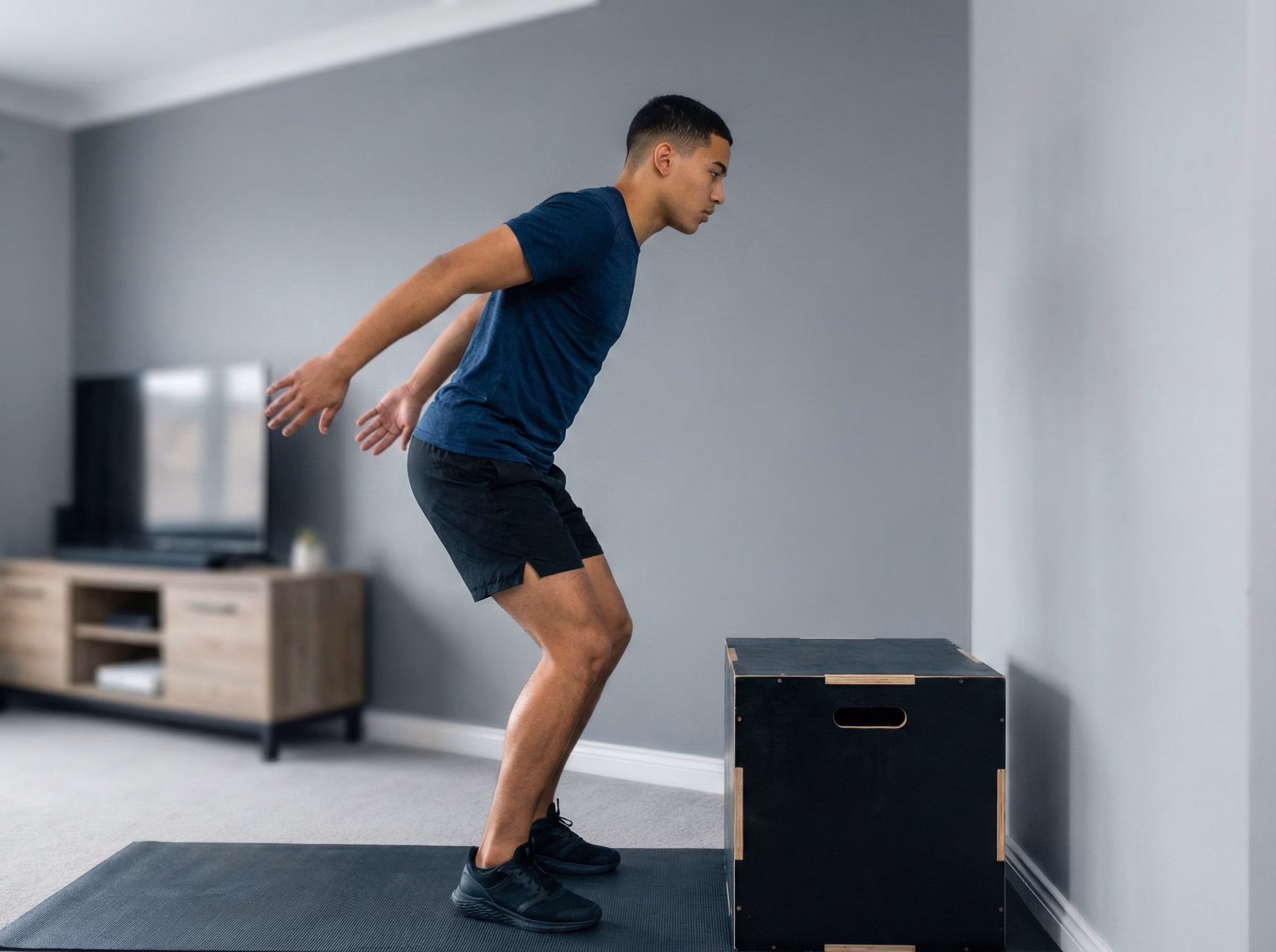 Step 1 – Teen in a loaded mini squat facing a box before jumping
