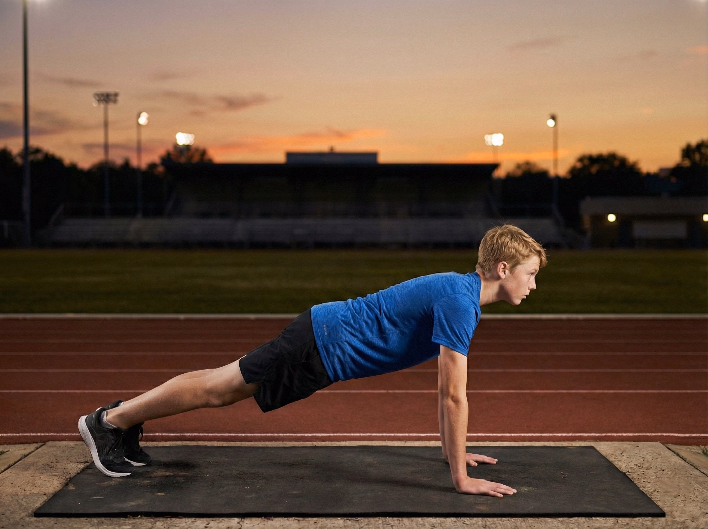 Step 2 – Teen holding a strong plank in the middle of a burpee