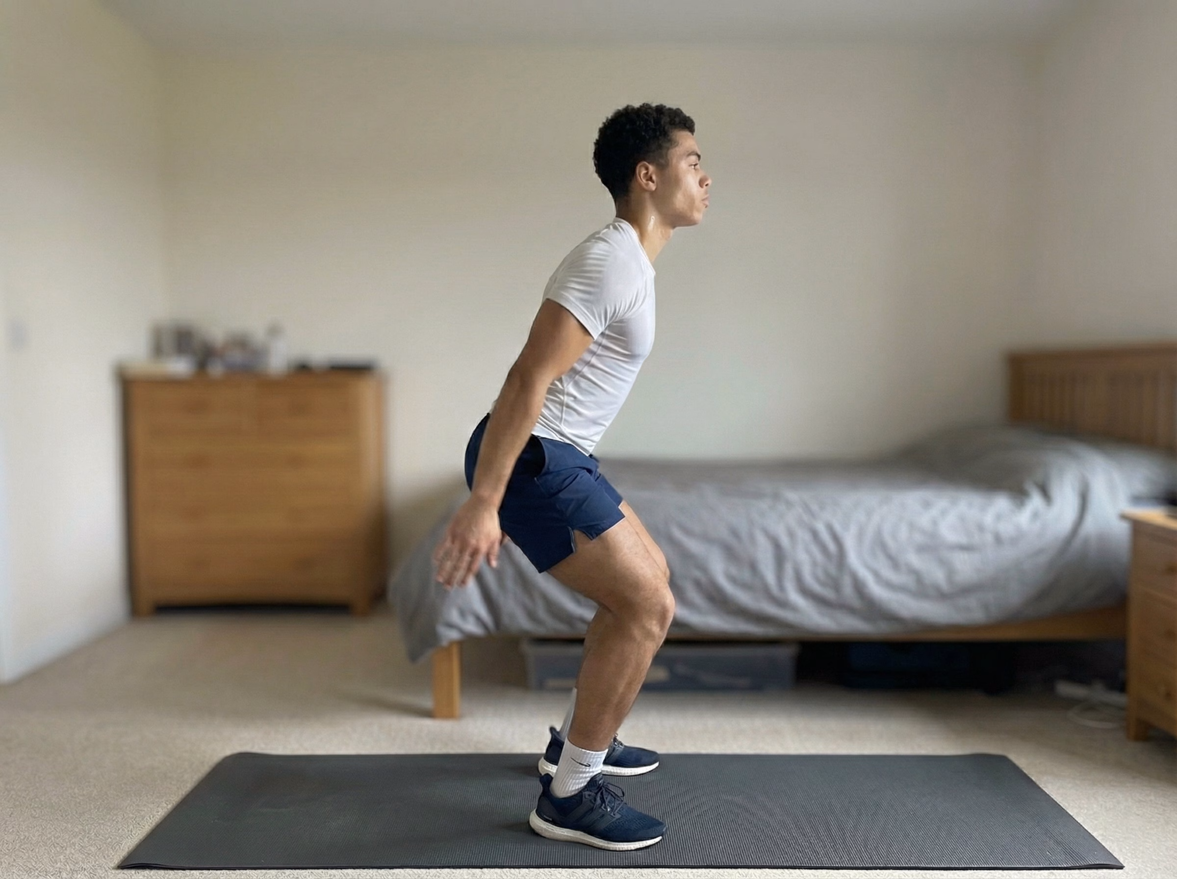 Step 2 – Teen in mid-air jump squat with a blue vertical line