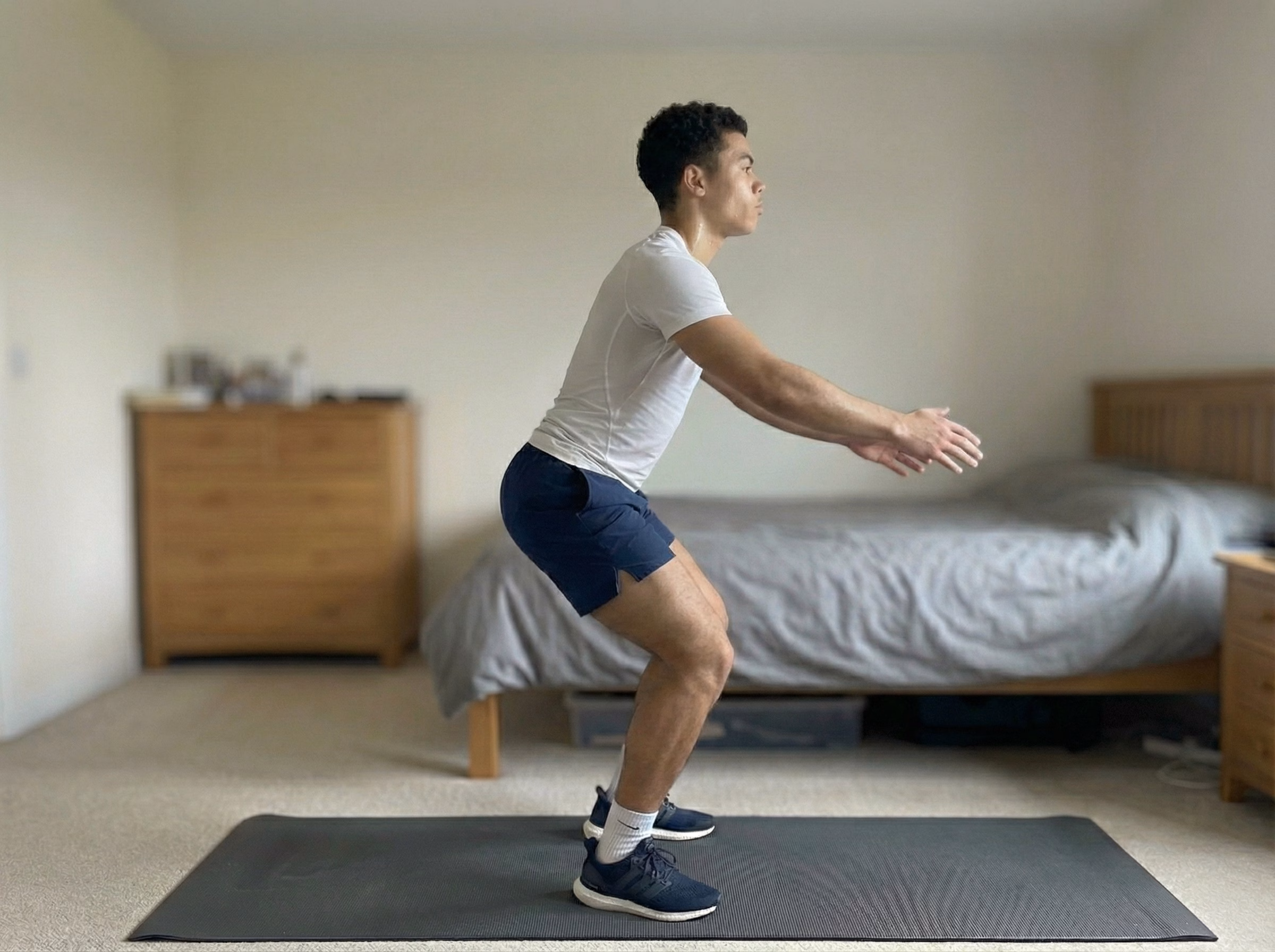 Step 3 – Teen landing softly in a squat with blue glow through legs and spine