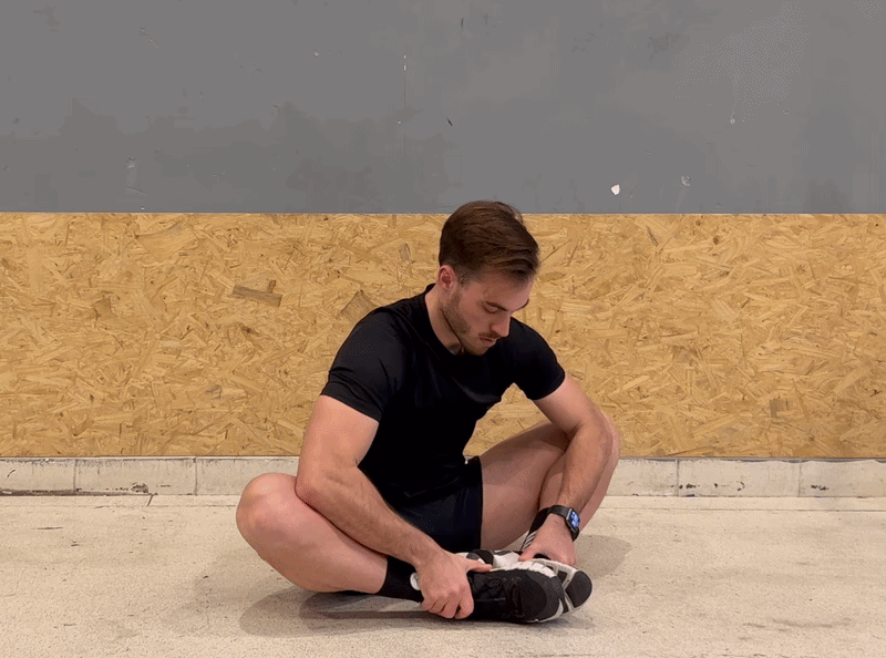 Person performing a butterfly stretch for hip mobility