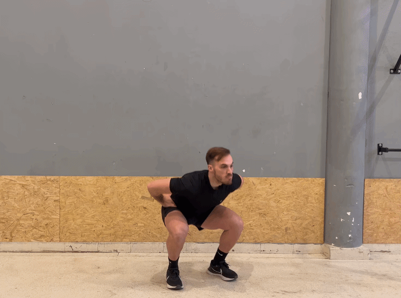 Hero – Teen athlete in a deep squat with a soft blue vertical glow from feet through torso